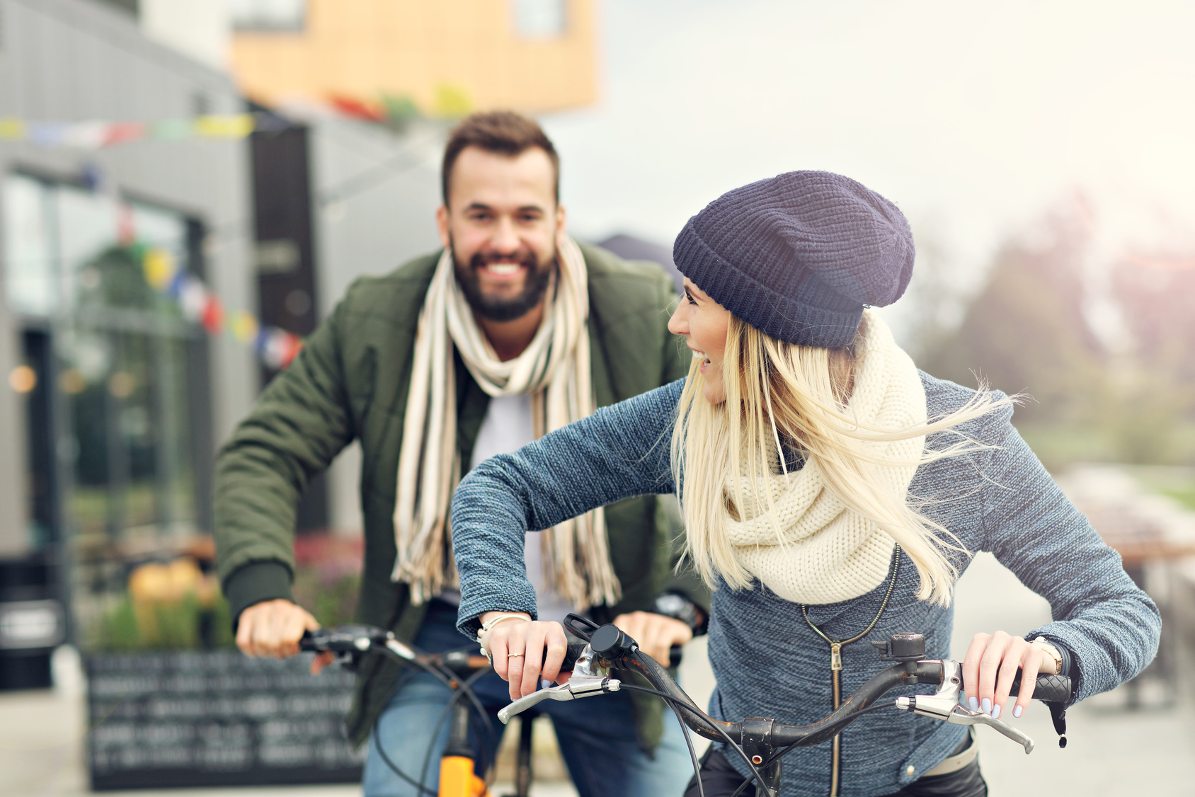 Young couple riding bikes and having fun in the city