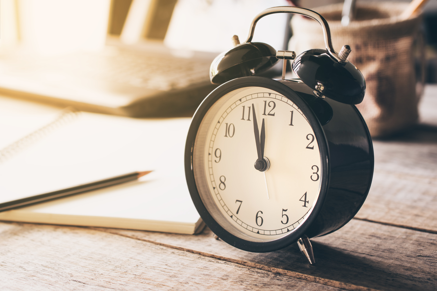 retro alarm clock on wood table with grunge background time for lunch concept.