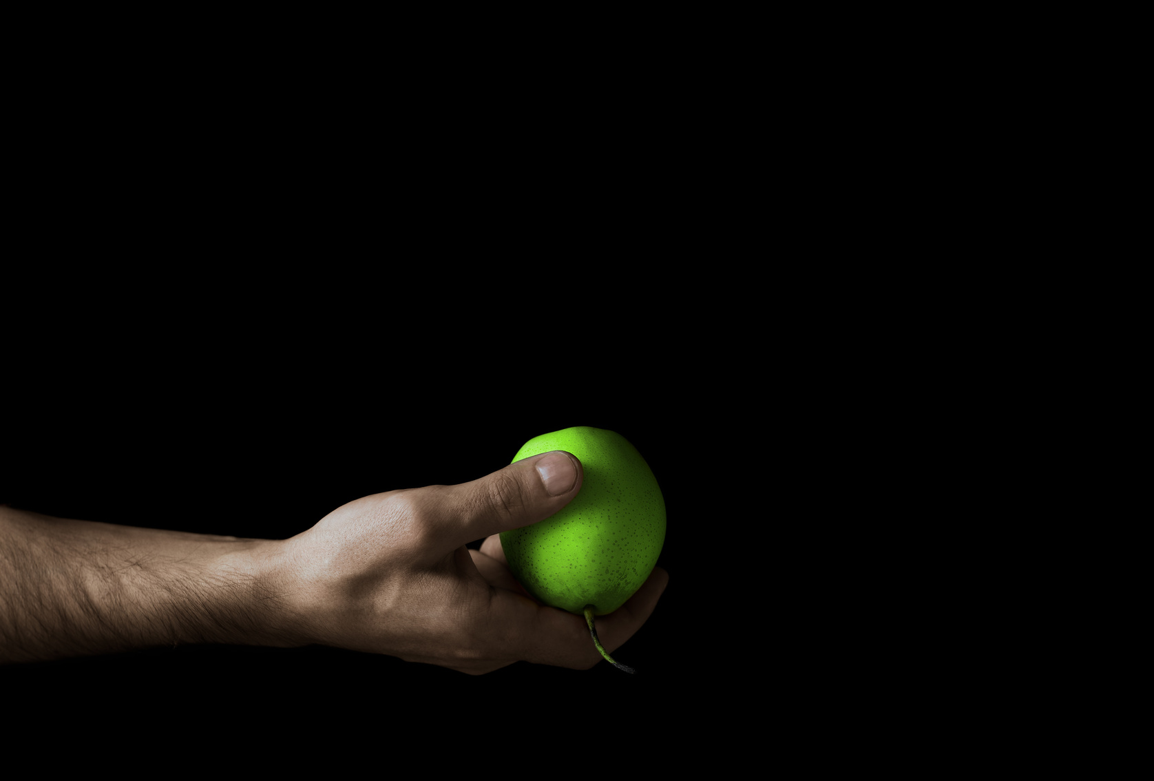 green apple in a man’s hand