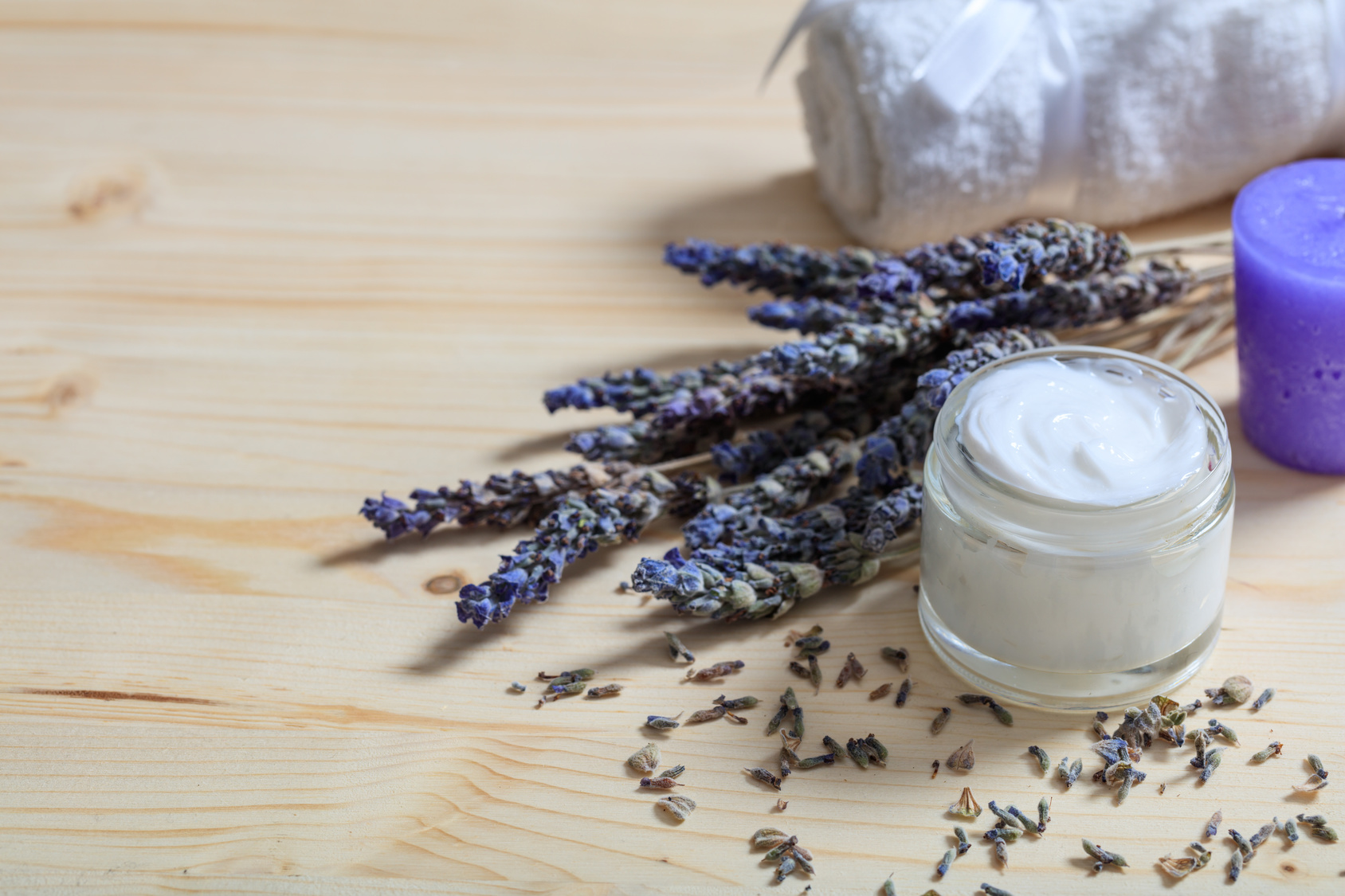 Moisturizing cream and lavender on wooden background