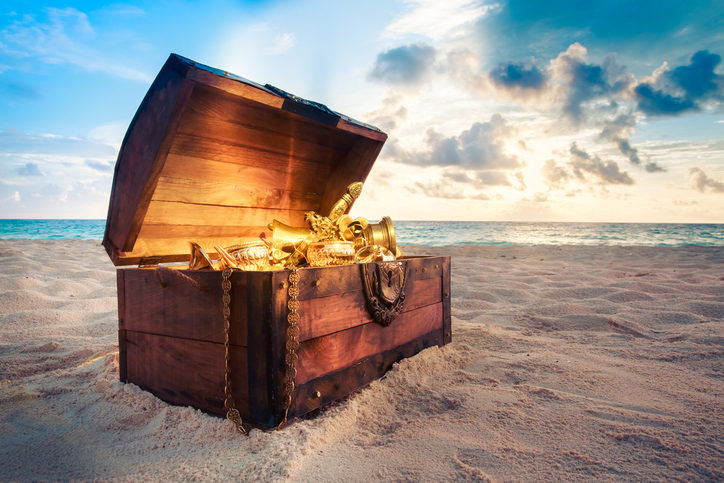 Open treasure chest on the beach