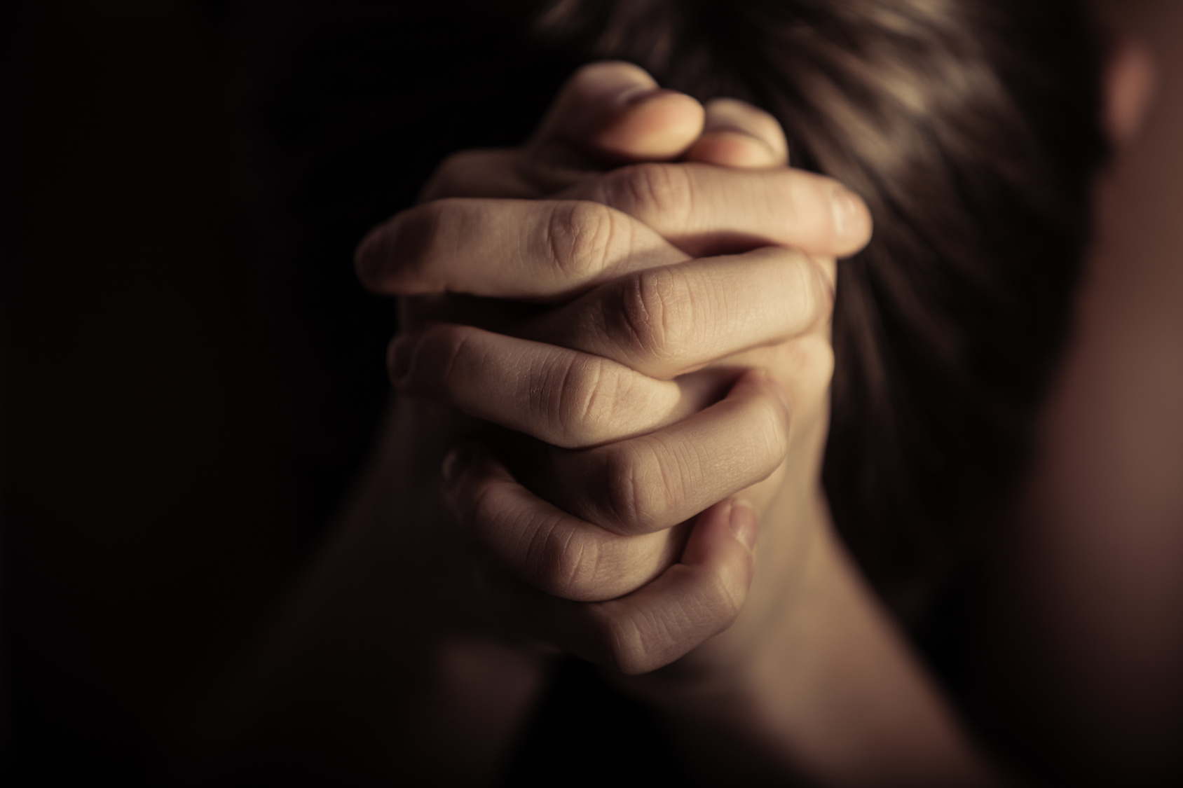 Hands folded together in prayer