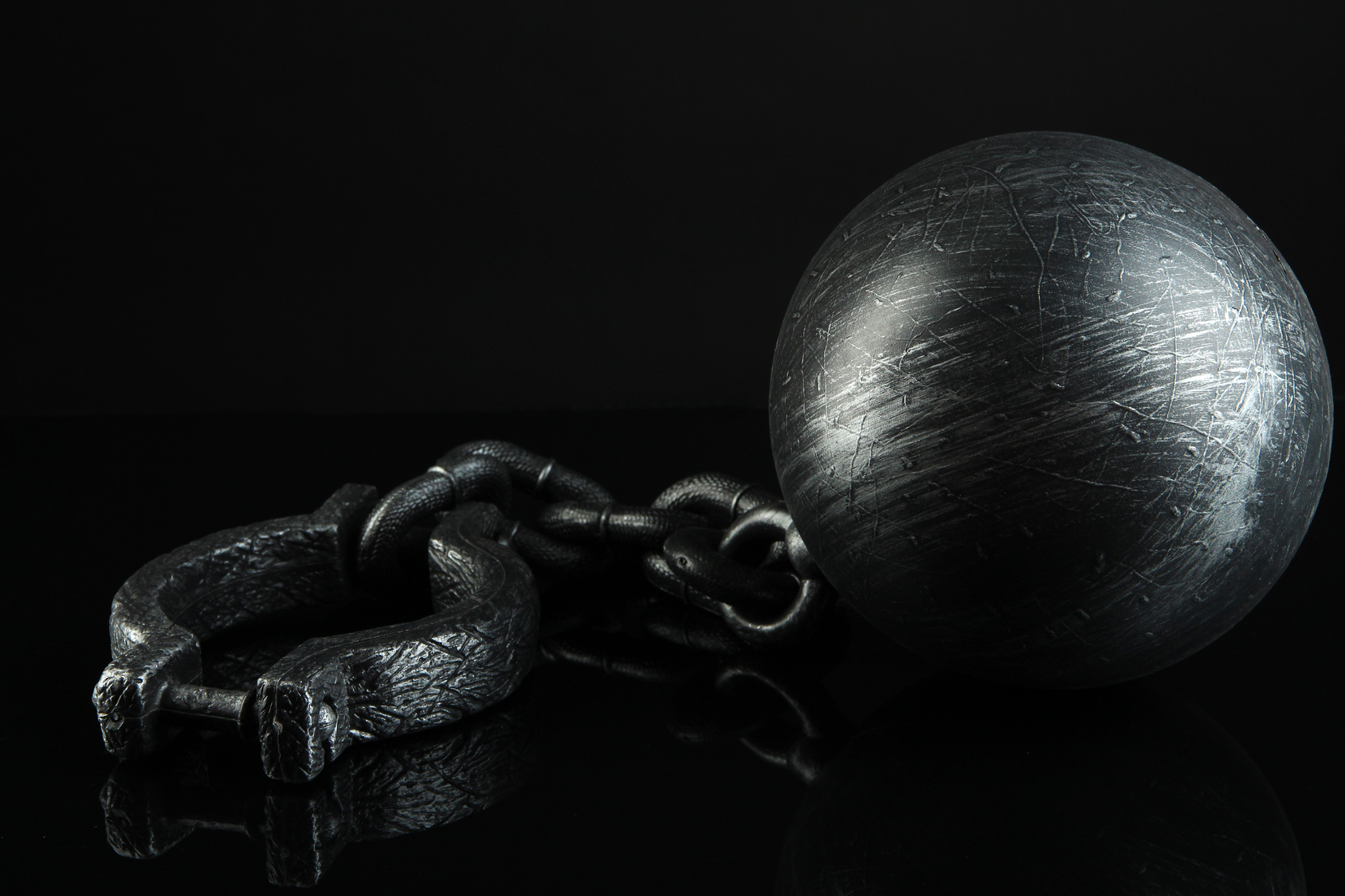 Ball and chain on black background