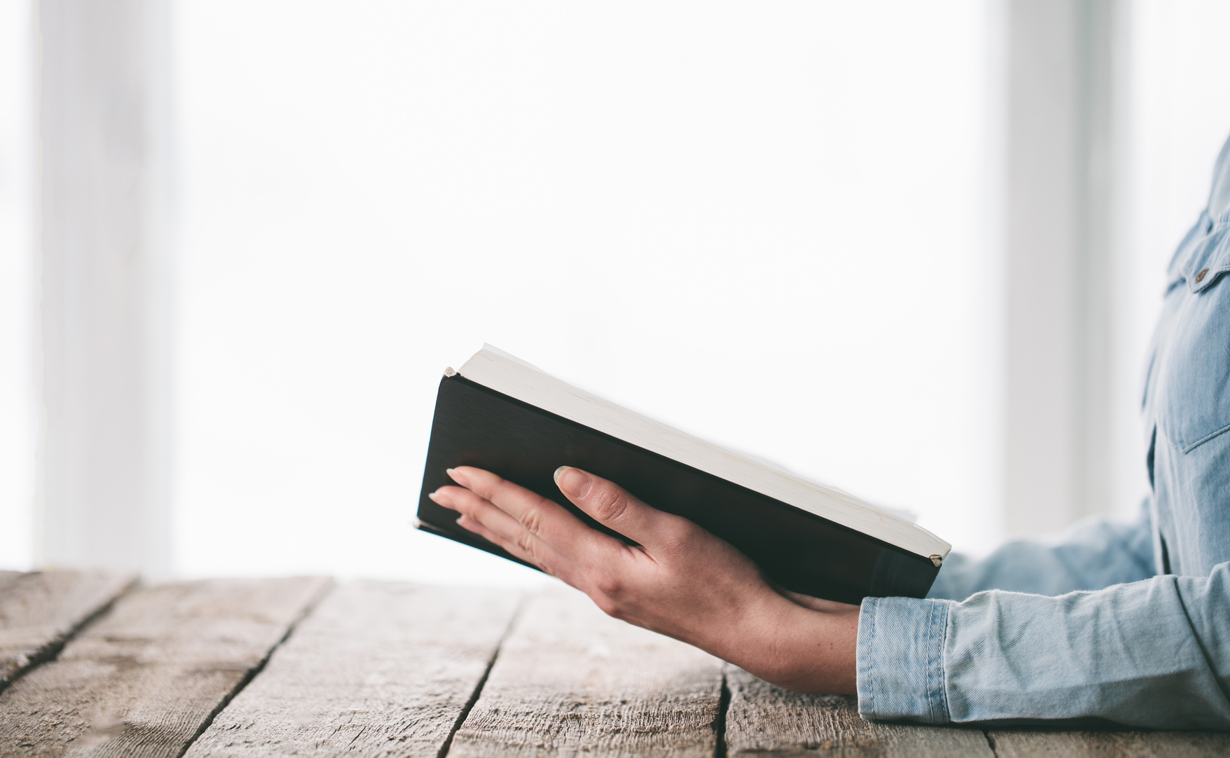 Woman reading and praying over a Bible