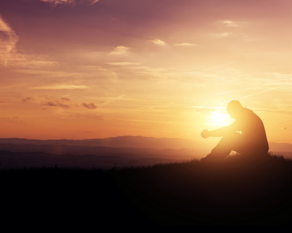 praying-at-sunrise-picture-id467439059