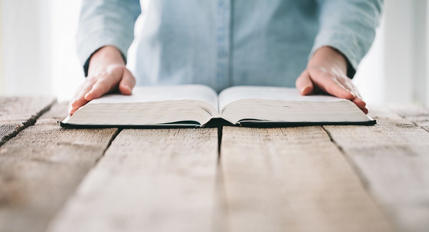 Woman reading and praying over Bible