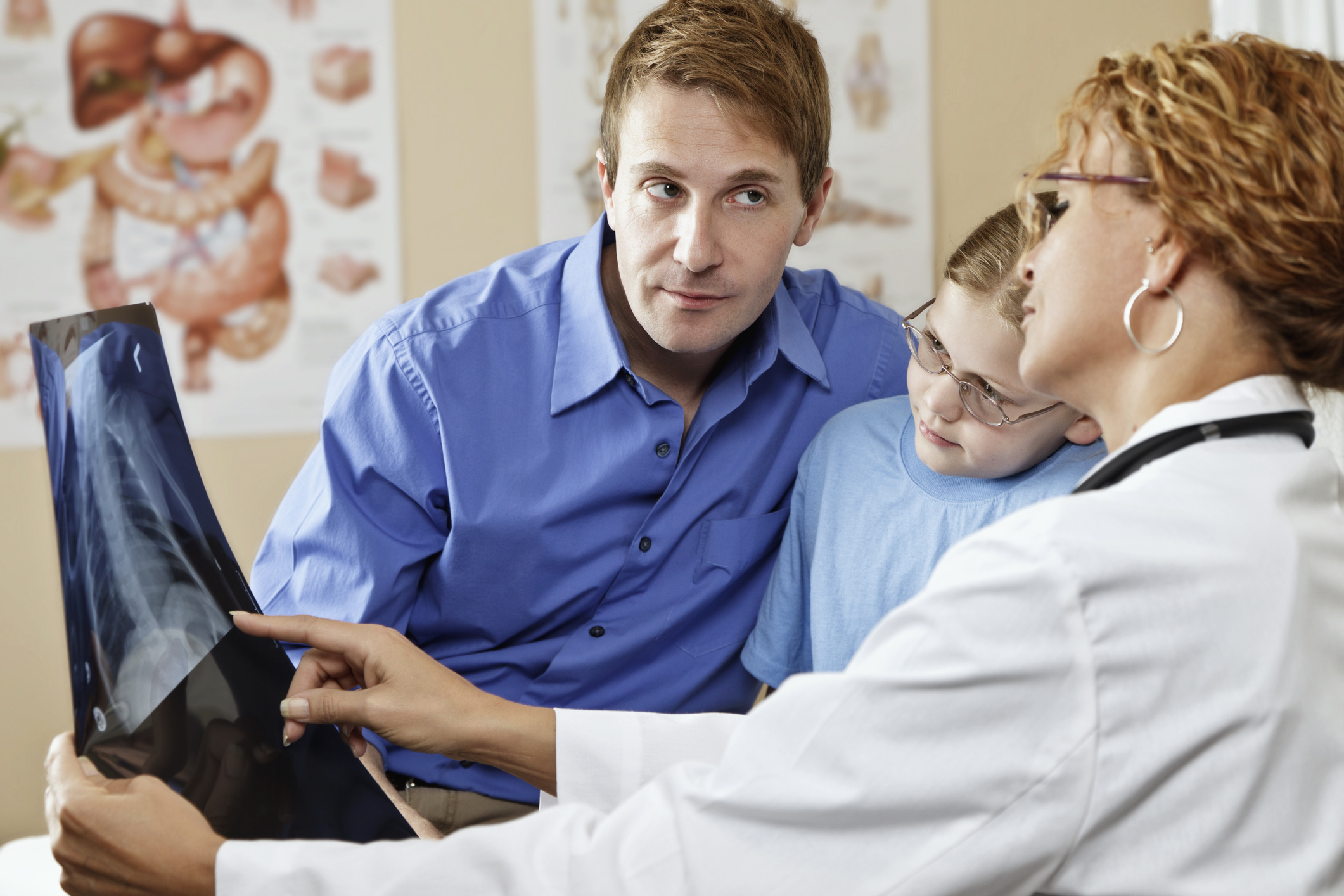 Doctor explaining Xray to Young Patient With Parent