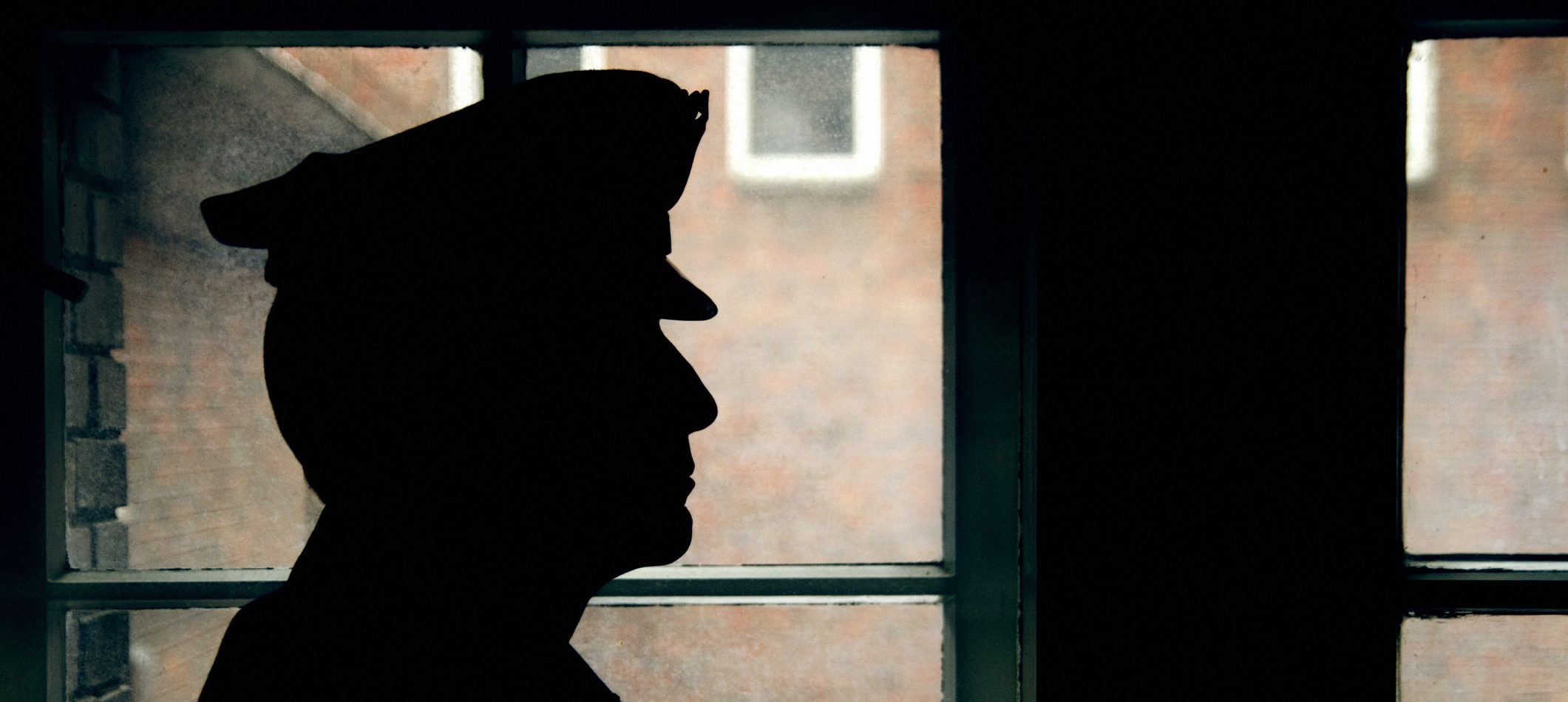 Silhouette of a prison/police warden