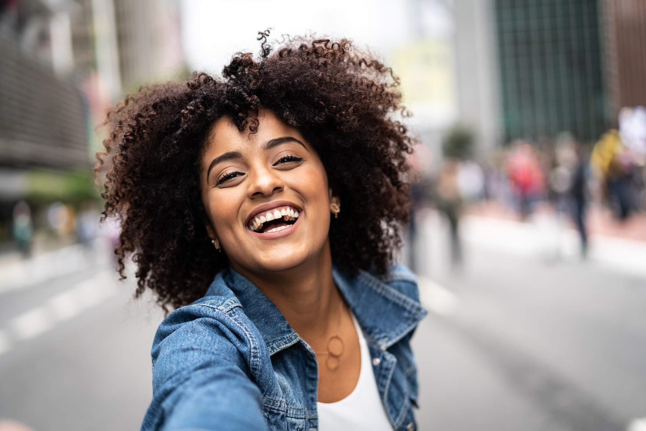 Fashionable Woman with Curly Hair at Street