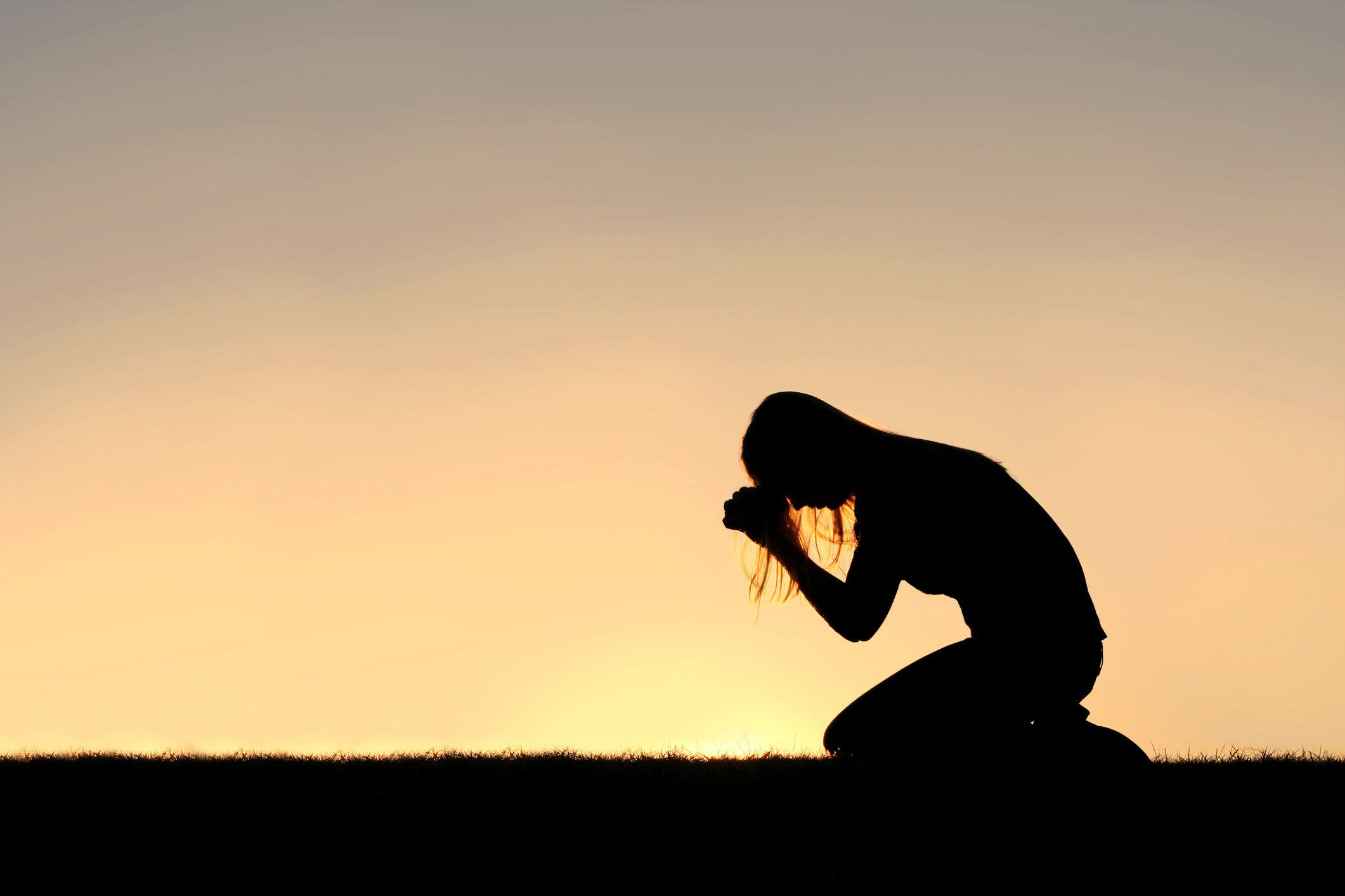 Christian Woman Sitting Down in Prayer Silhouette