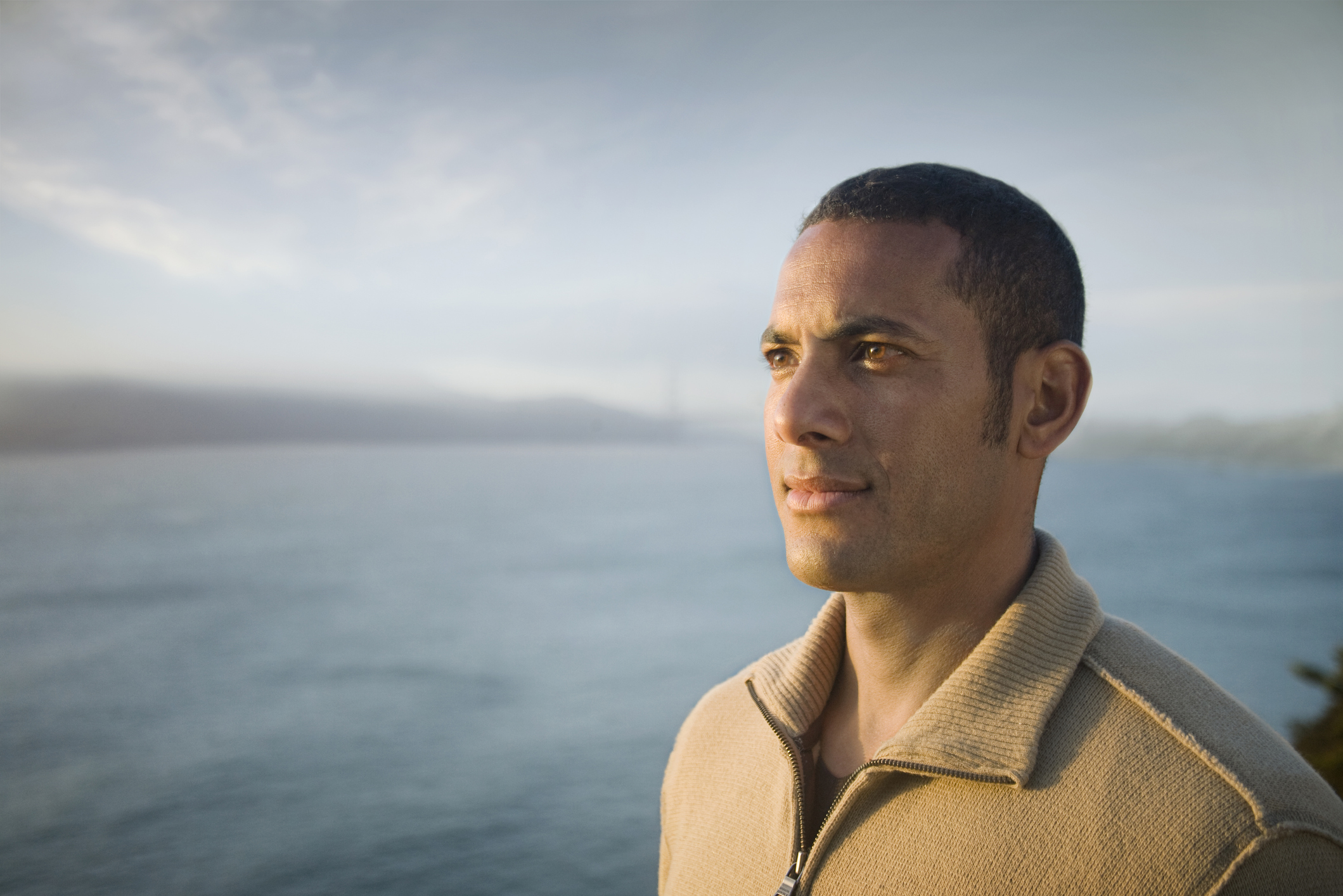 Pensive mixed race man near bay