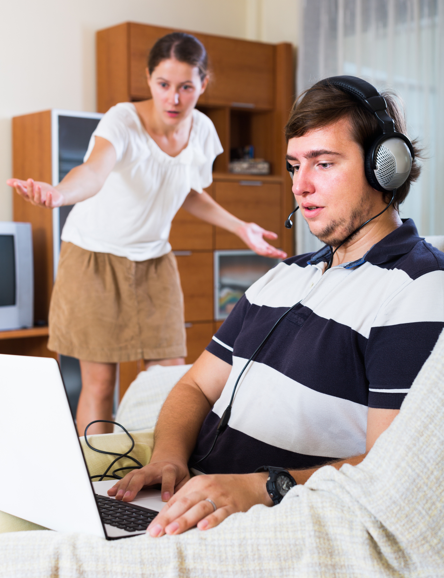 Man addicted playing  in laptop and wife
