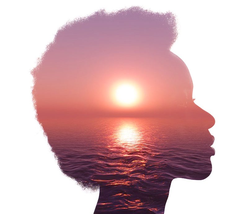 Multiple exposure image with sunrise and sea inside woman silhouette. Psychology concept