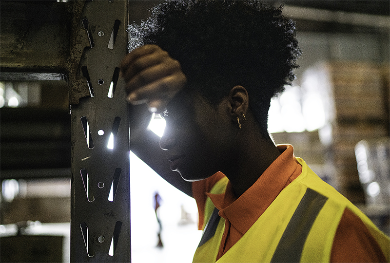Young worker woman feeling bad at warehouse