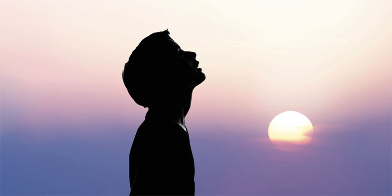 Young man with arms raised
