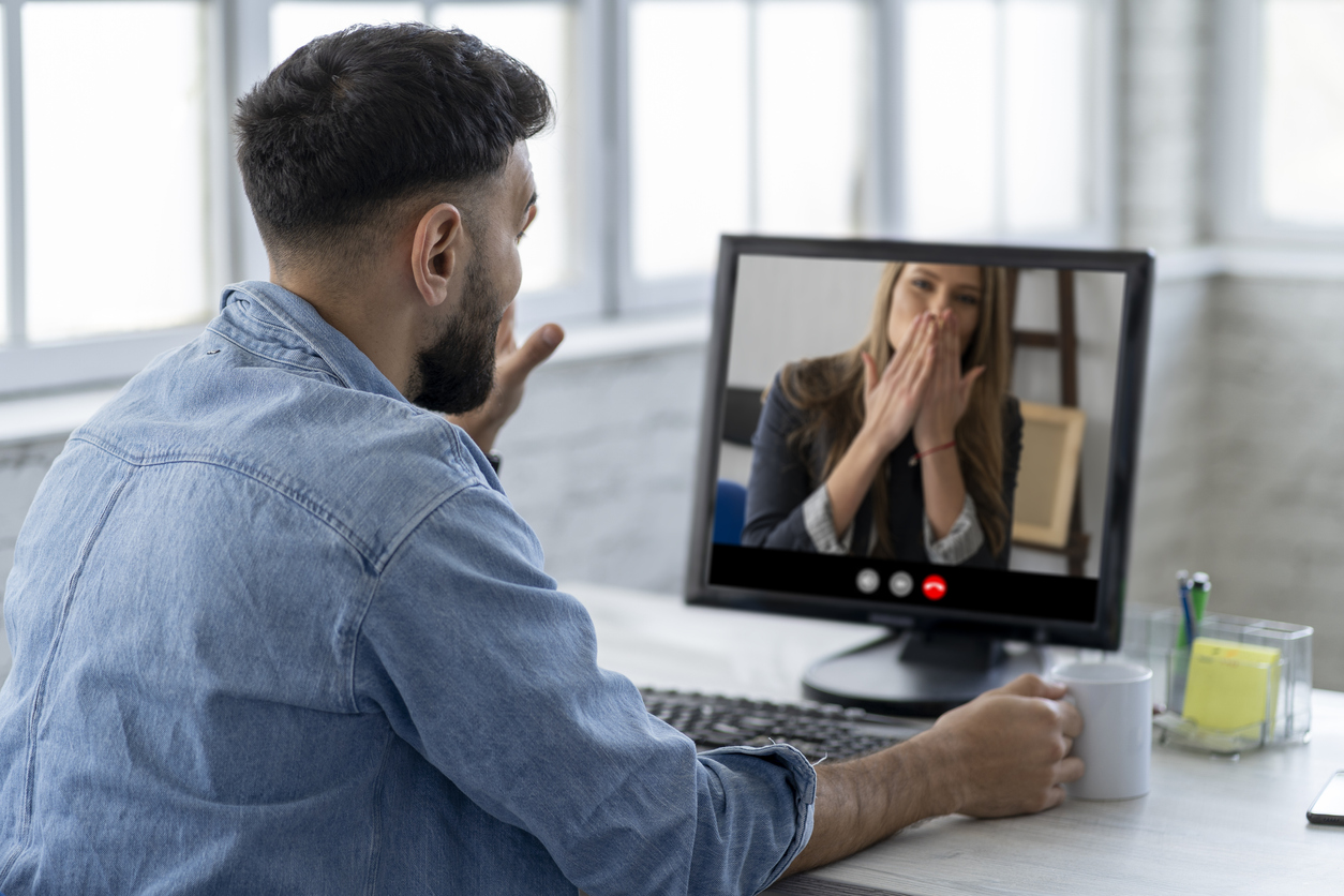 Back view of male speaking on video call with his girlfriend