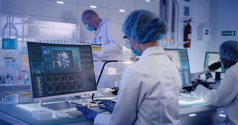COVID-19 – laboratory team working on coronavirus vaccine. Protective workwear