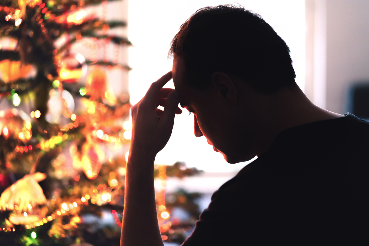 Sad on Christmas. Unhappy, lonely or tired man with stress, grief or depression. Family fight, loneliness, frustration or money problem on Xmas.