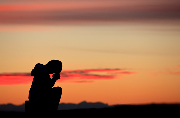 Silhouette of Boy Praying