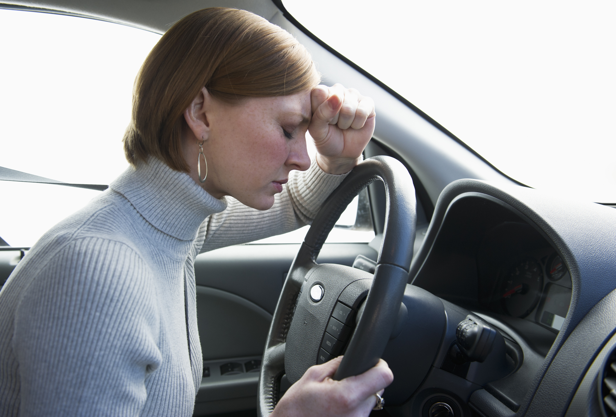 USA, New Jersey, Jersey City, woman driving car looking upset