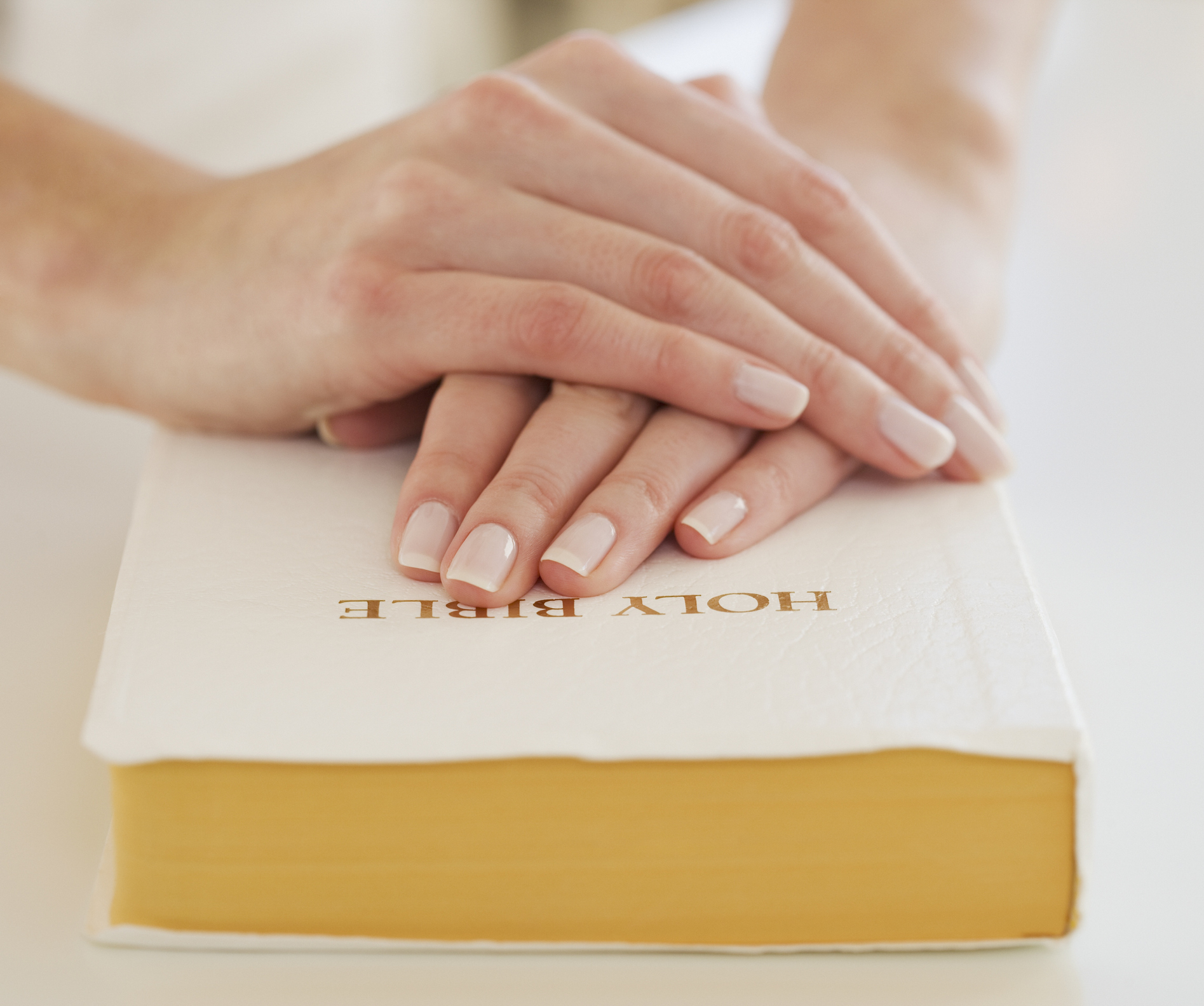 Woman’s hands on Bible