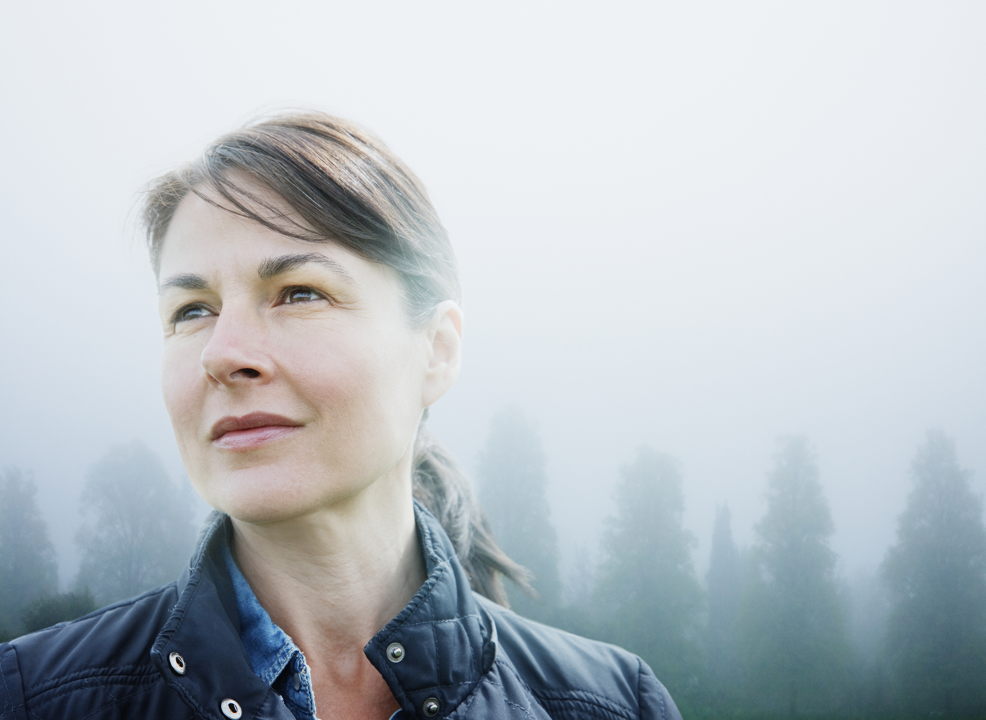 Female looking to horizon in rural scene