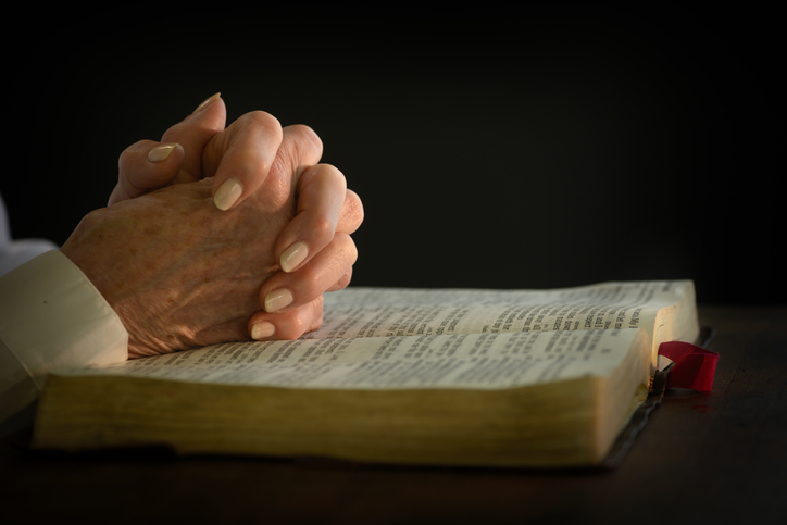 Woman&#8217;s hands on open bible