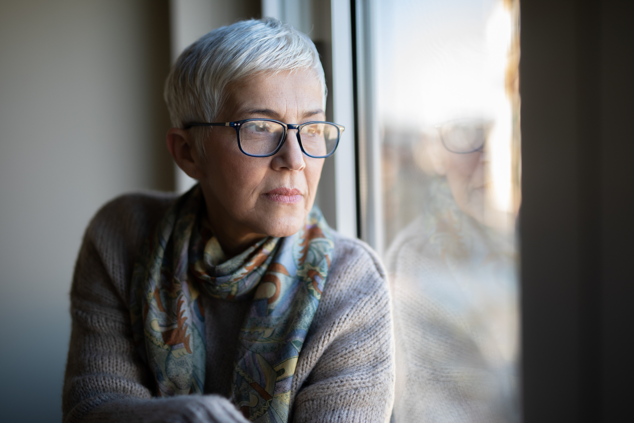 Portrait of beautiful mature woman relaxing by the window