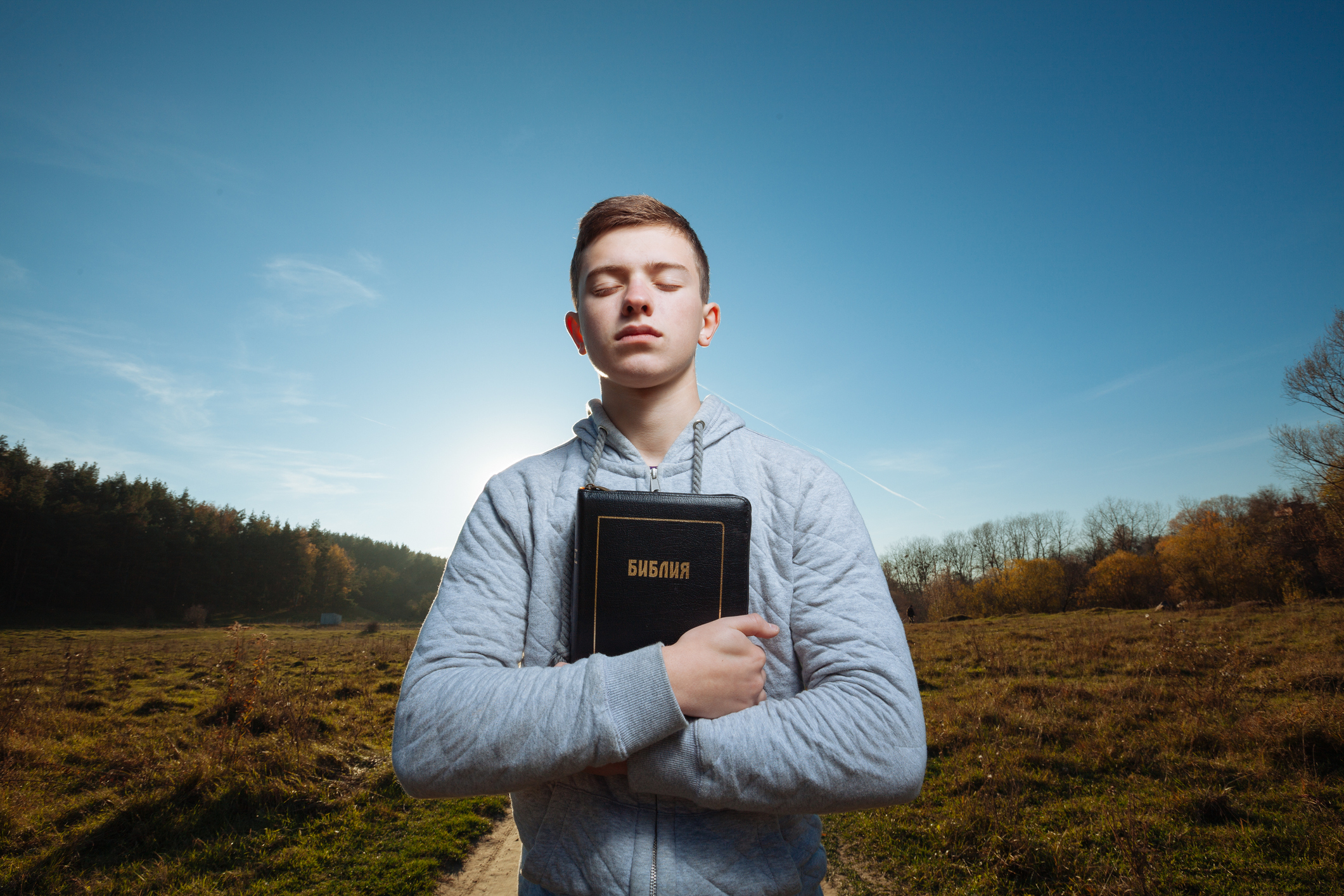 Teenager hugging a bible