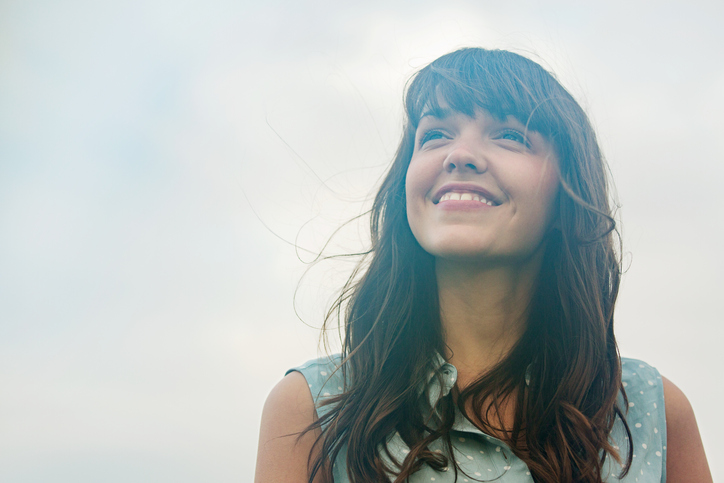 Woman looking up, smiling.