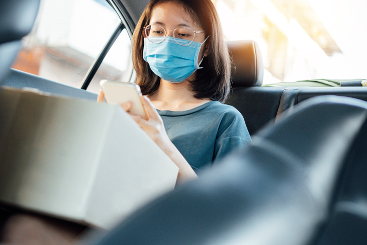 Young Asian teenages wearing a protective face mask to prevent the spread of coronavirus, and moving to her house to quarantine . a global health emergency Covid-19