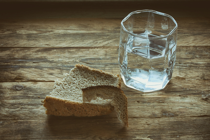 glass of water and hunk black bread