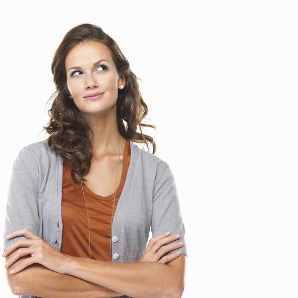 Studio portrait of woman thinking and looking up