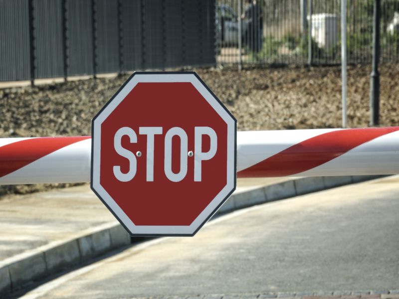 Security entry with big red Stop sign on the beam