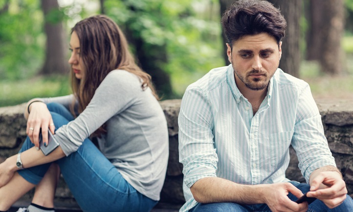 Young couple in relationship difficulties staying away from each other