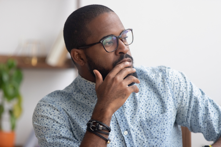 Pensive African American businessman pondering business strategy
