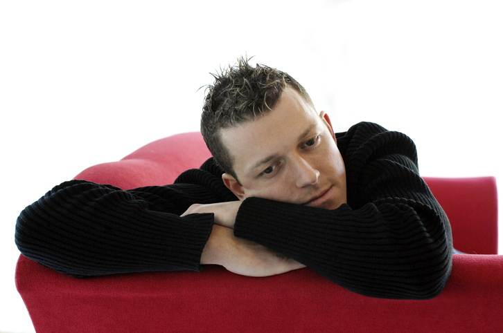 young man on red sofa