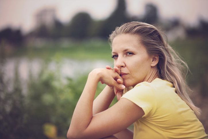 Contemplating woman outdoor portrait
