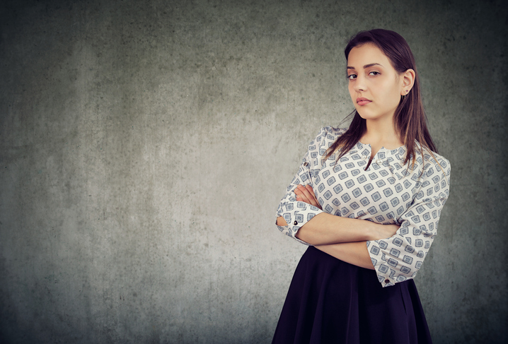 Arrogant young woman with arms crossed