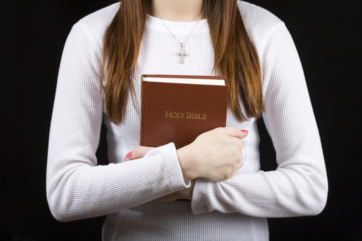 Teenage Catholic with bible