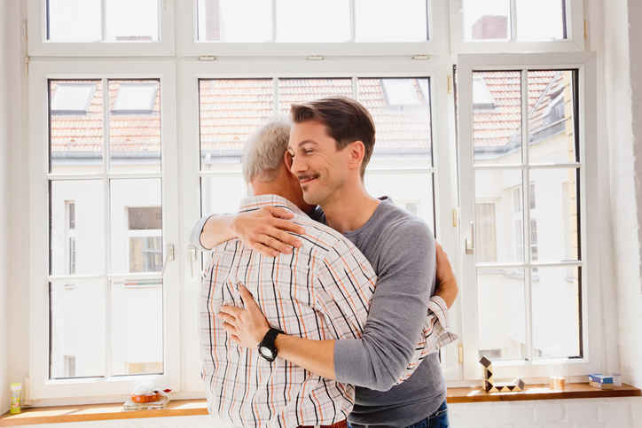 Adult son hugging his dad