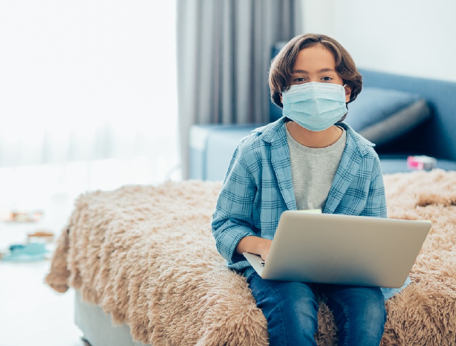 Child with laptop during the pandemic at home