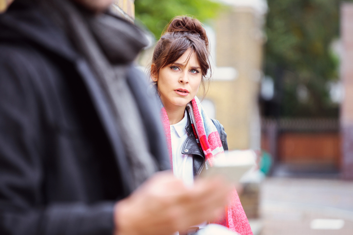 Outdoor portrait of angry women with her boyfriend in the front