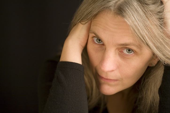 Mature female model with a concerned glance to camera