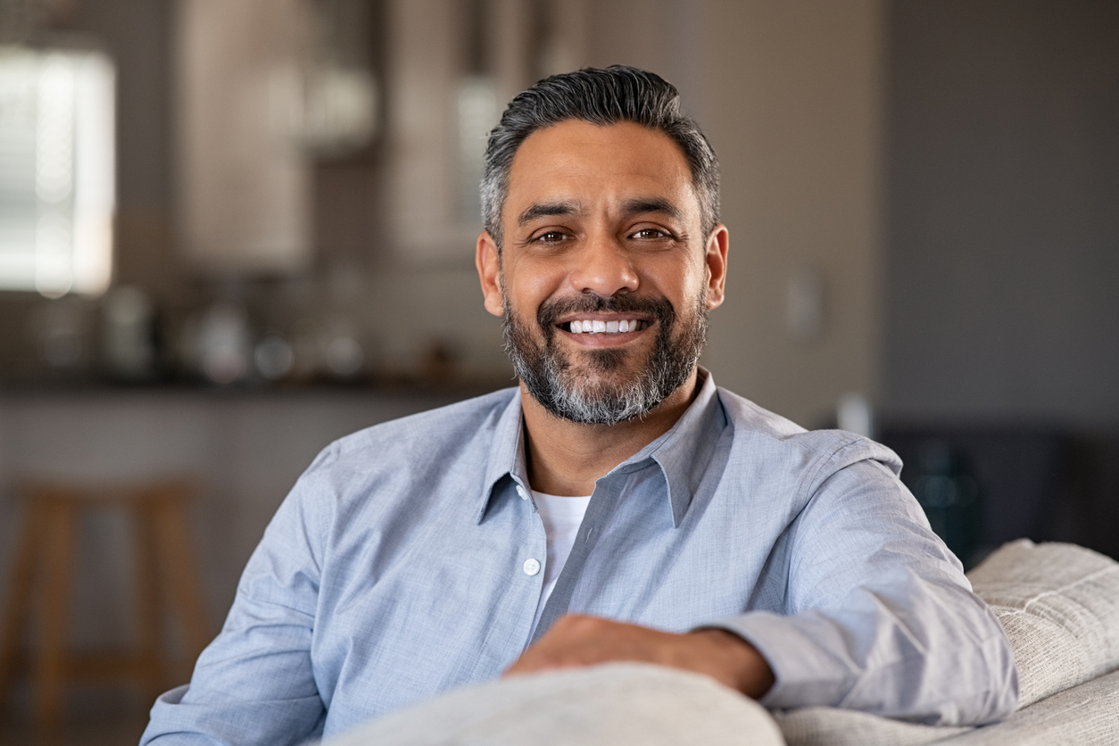 Portrait of happy indian man smiling at home