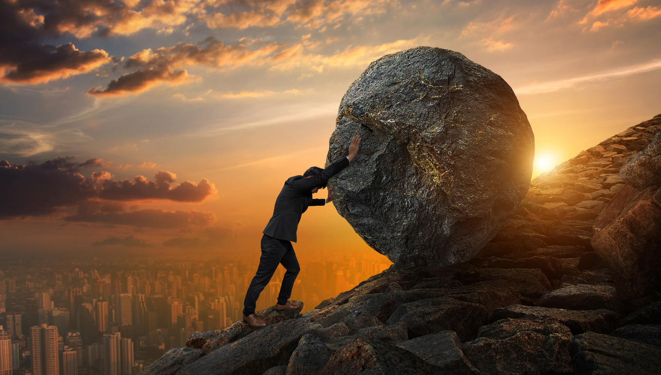 Business man pushing large stone up to hill , Business heavy tasks and problems concept.