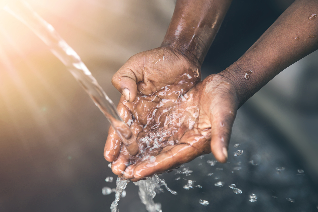 Hands of poor child &#8211; scoop drinking water, Africa