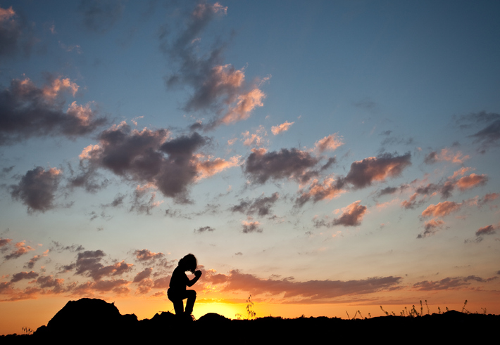 Silhouette of Young Boy Praying