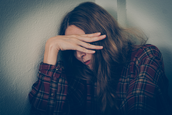 Depressed woman covering her face