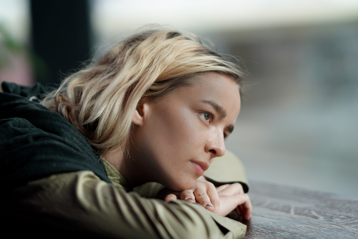 Woman absorbed  in thoughts looking out the window